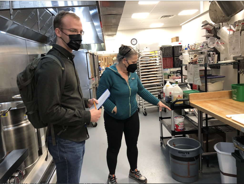 Two people talking in an industrial kitchen